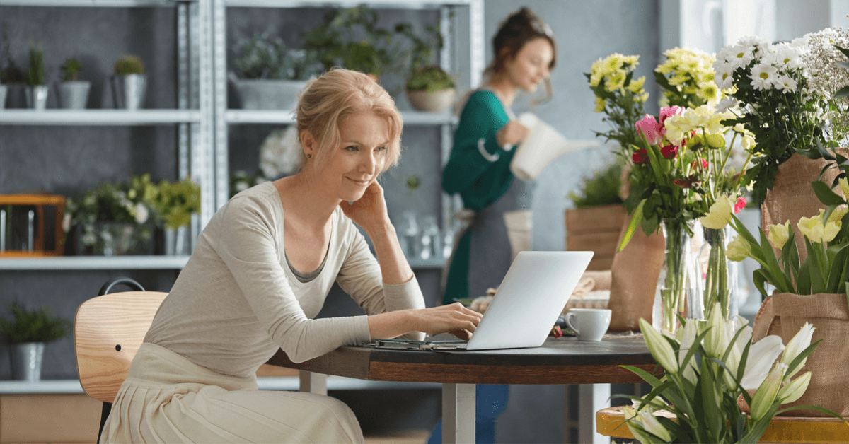 Florist working on her laptop evaluating her marketing strategy